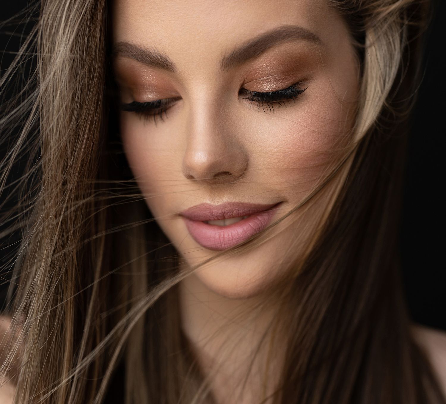 Close-up of a woman's face with flowing hair.