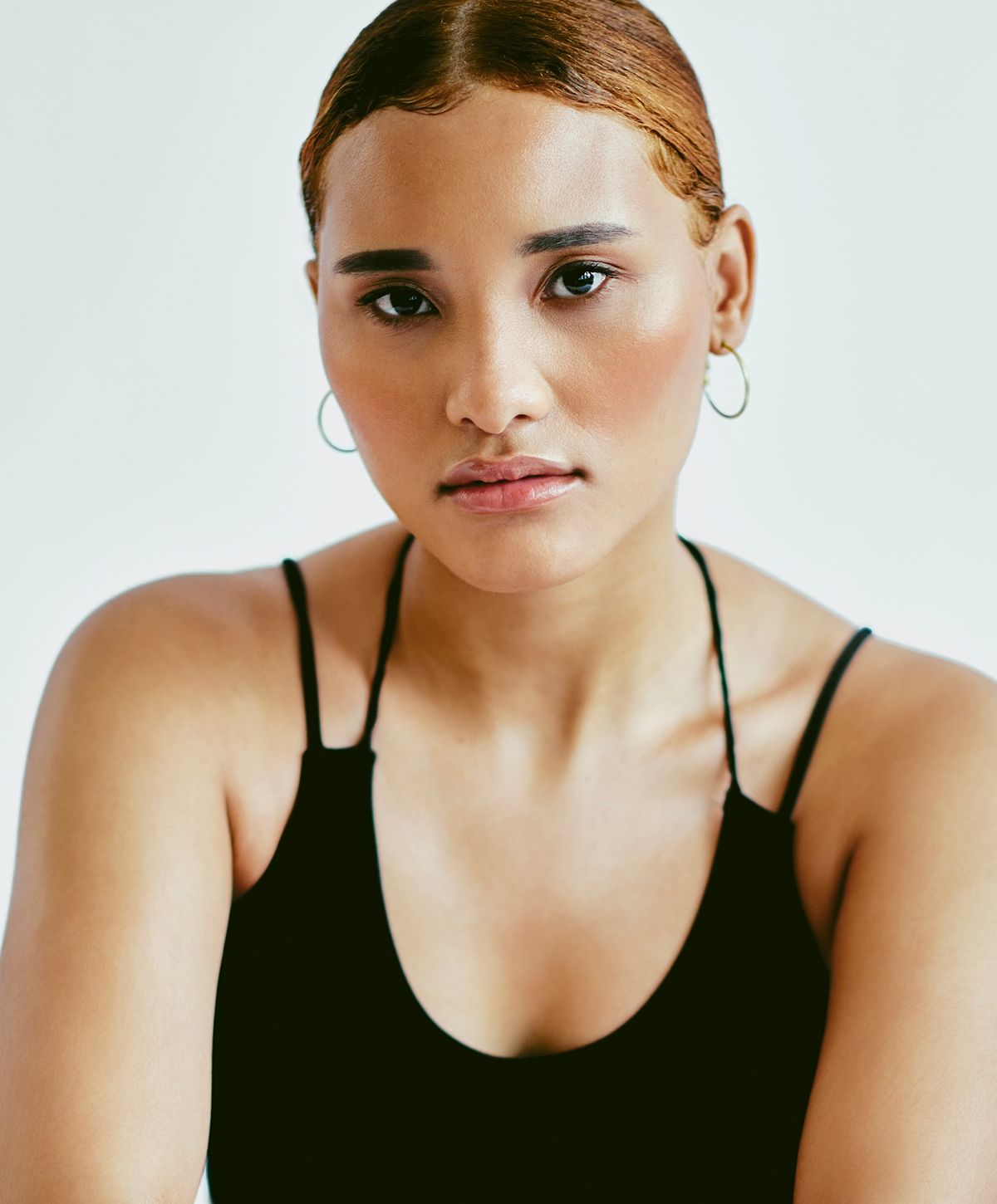 Close-up of a woman relaxing with neutral background.