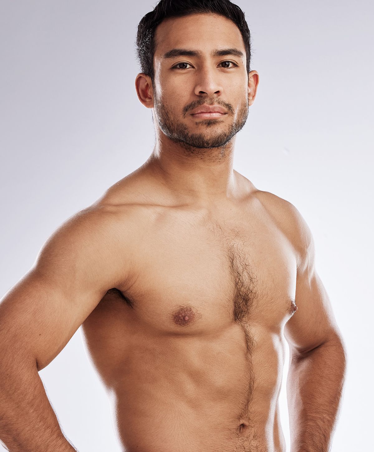 Man posing confidently against a neutral background.