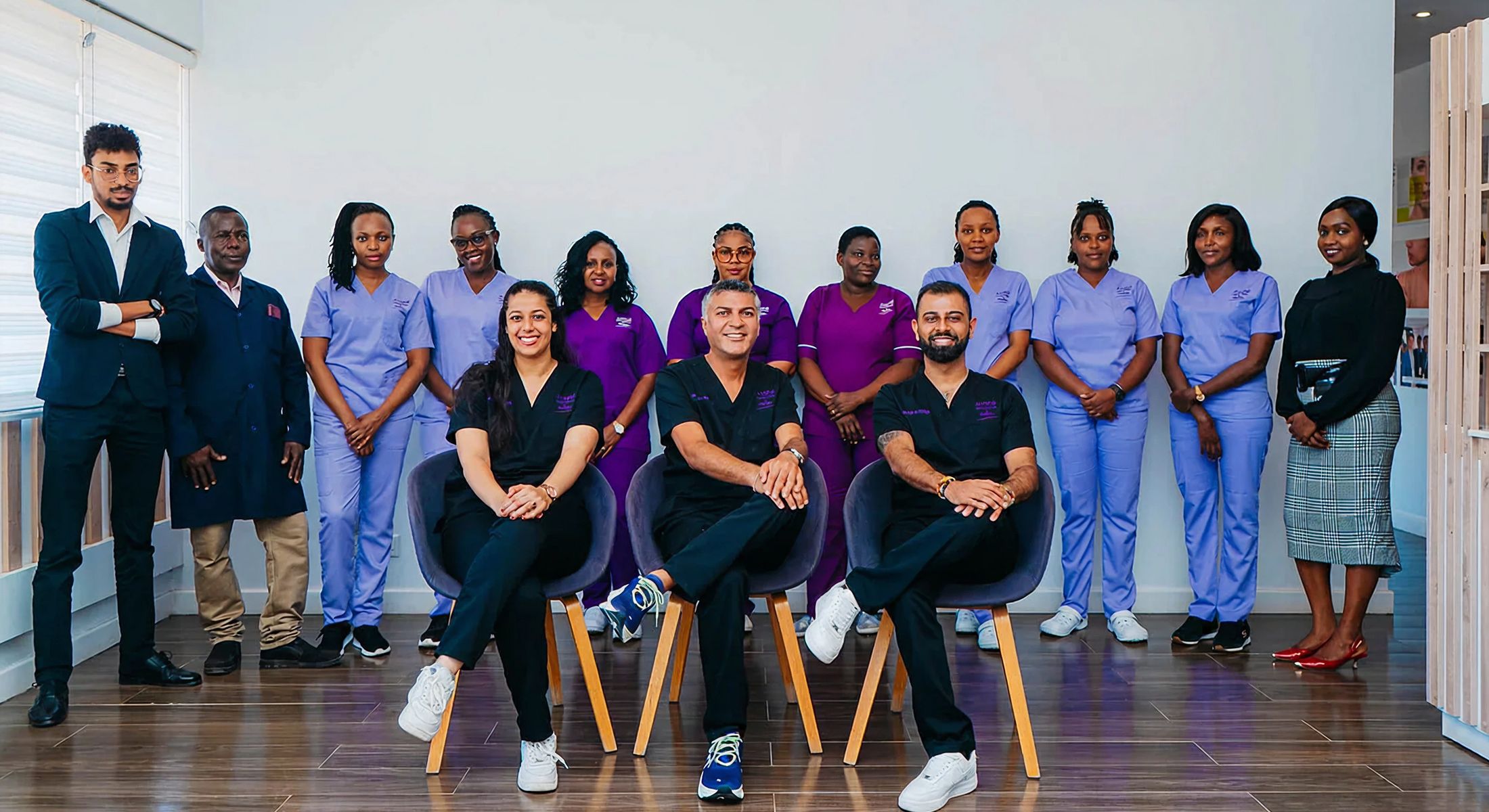 Medical team group photo with diverse professionals.