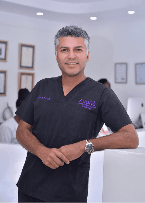Smiling doctor in medical scrubs, professional setting.