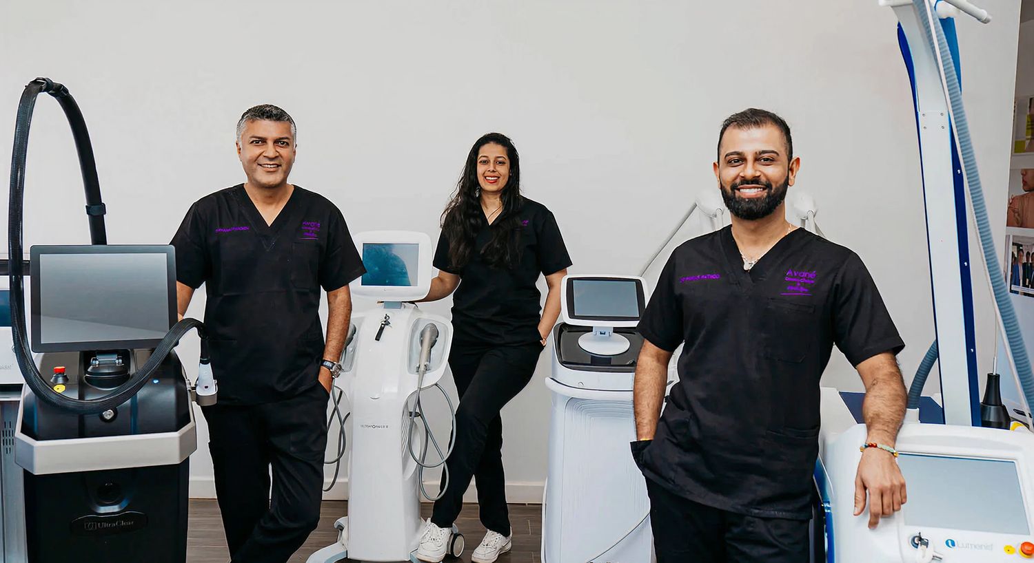 Medical professionals with aesthetic treatment equipment.