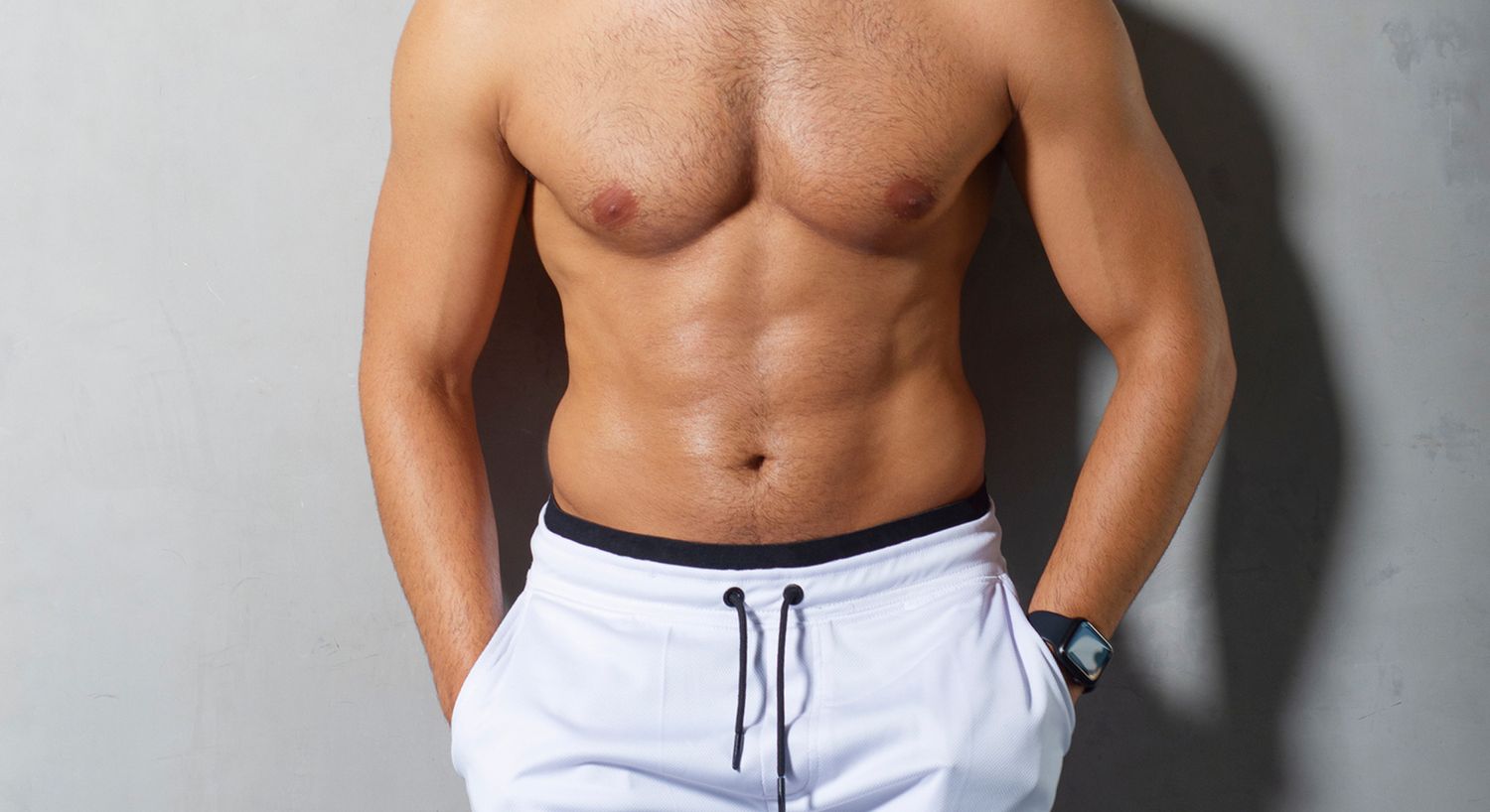 Male torso with defined abs and shorts.