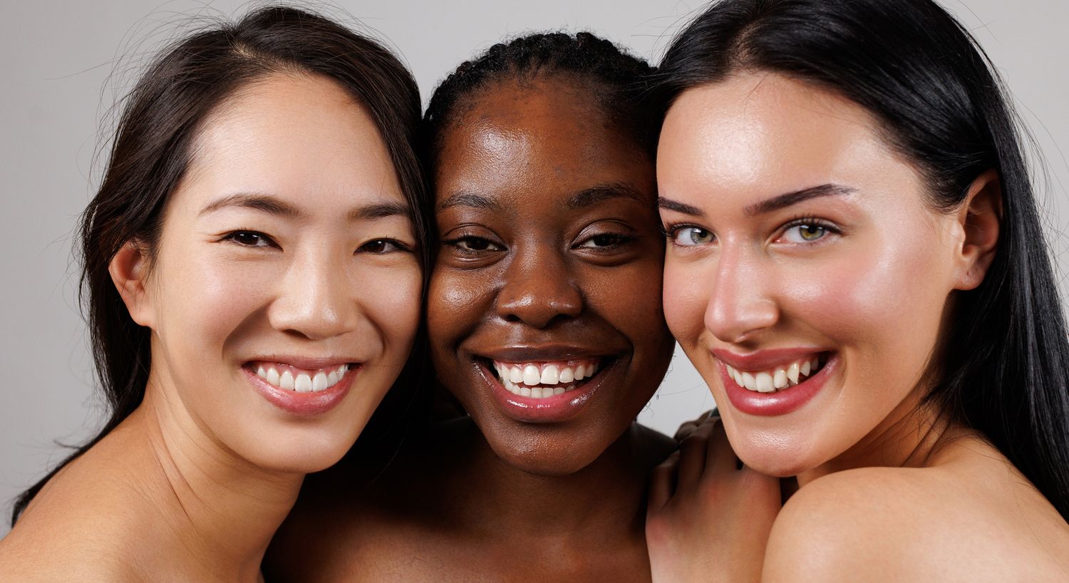 Smiling women of different ethnicities together.