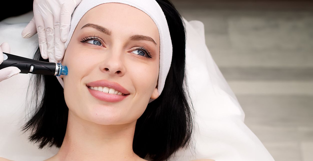 Woman receiving a facial treatment in a clinic.